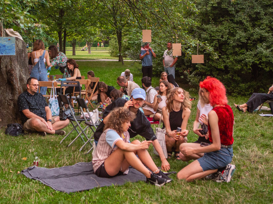 Photo. Group of people meeting in a park and talking. 