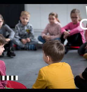 Zdjęcie. Dzieci siedzą w kręgu na podłodze. Po lewej stronie zdjęcia napis: Warszawa w budowie, Walka o ulice. Festiwal.