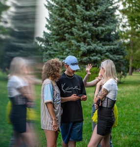 Photo. Group of people meeting in a park and talking. 