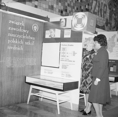 Zdjęcie ukazujące postać kobiecą stojącą obok makietki z napisem: związek zawodowy nauczycielstwo polskich szkół średnich